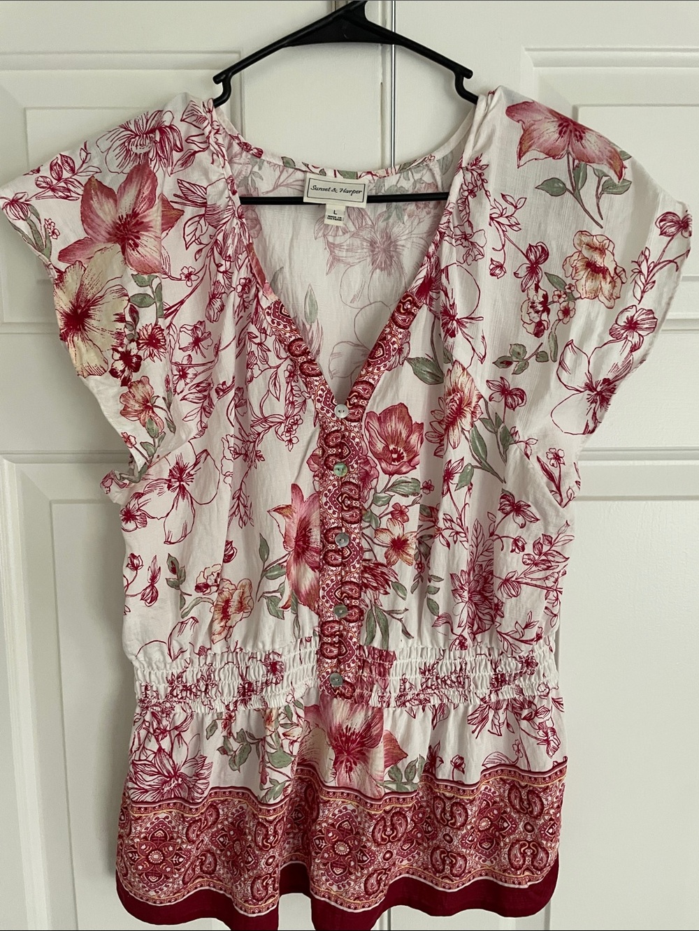 White Floral V‑Neck Blouse with Red & Green Accents and decorative buttons